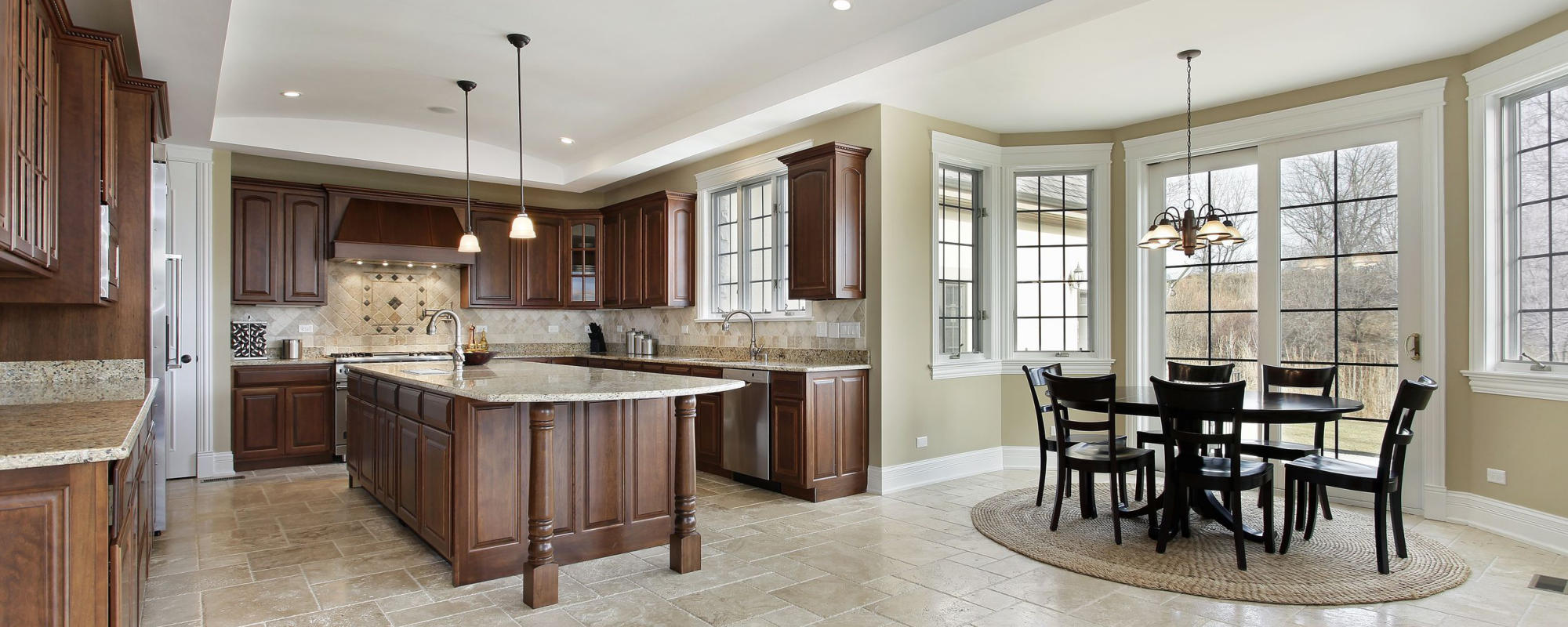 Wide shot of light fixtures installed above a kitchen and dinning area.