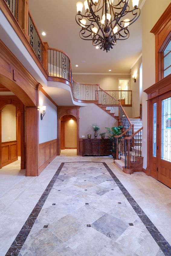 Lit chandelier above a home's entry way.